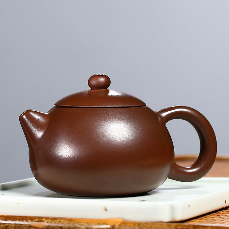Xishi Zisha Teapot - alternate angle on white porcelain tray with bamboo mat